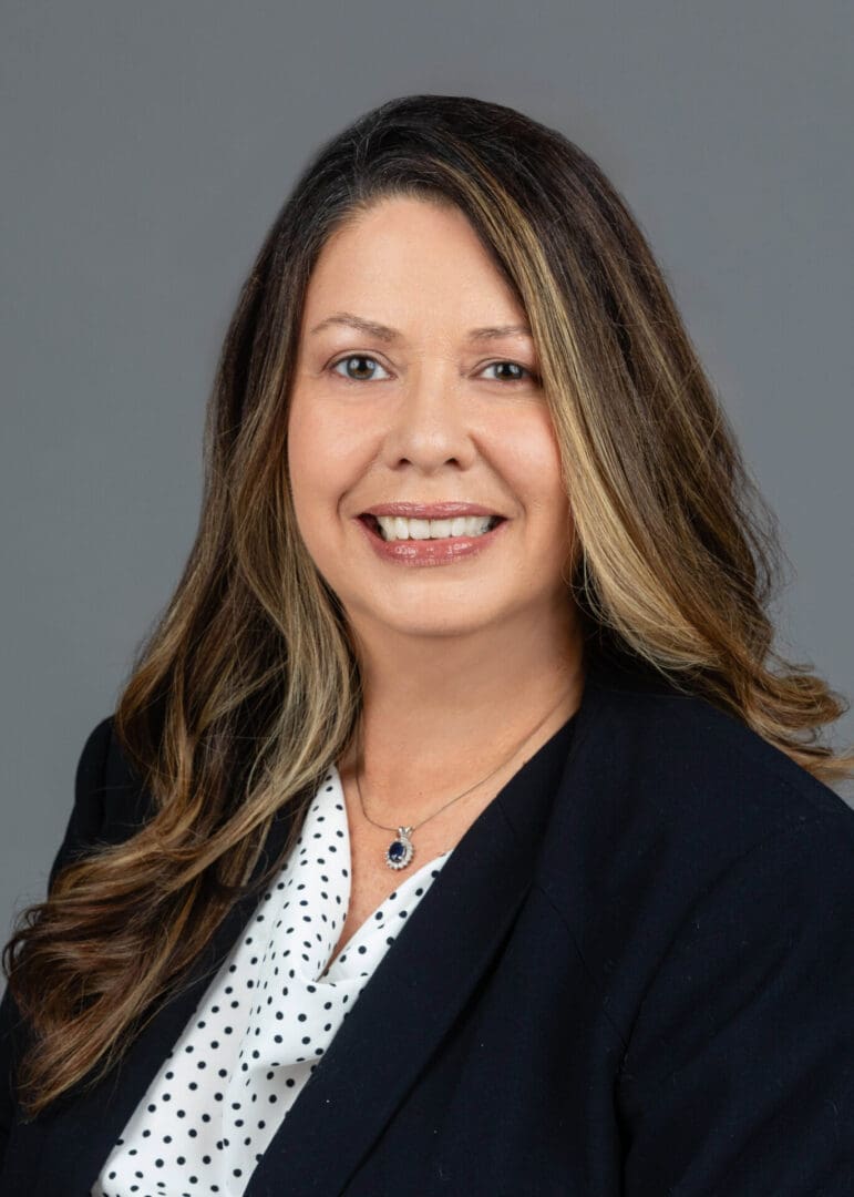 A woman with long hair wearing a black jacket.